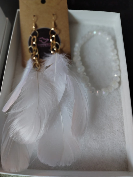 White feather earrings with white crystal beaded bracelet.