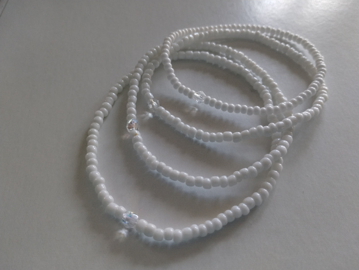 White bead anklets.